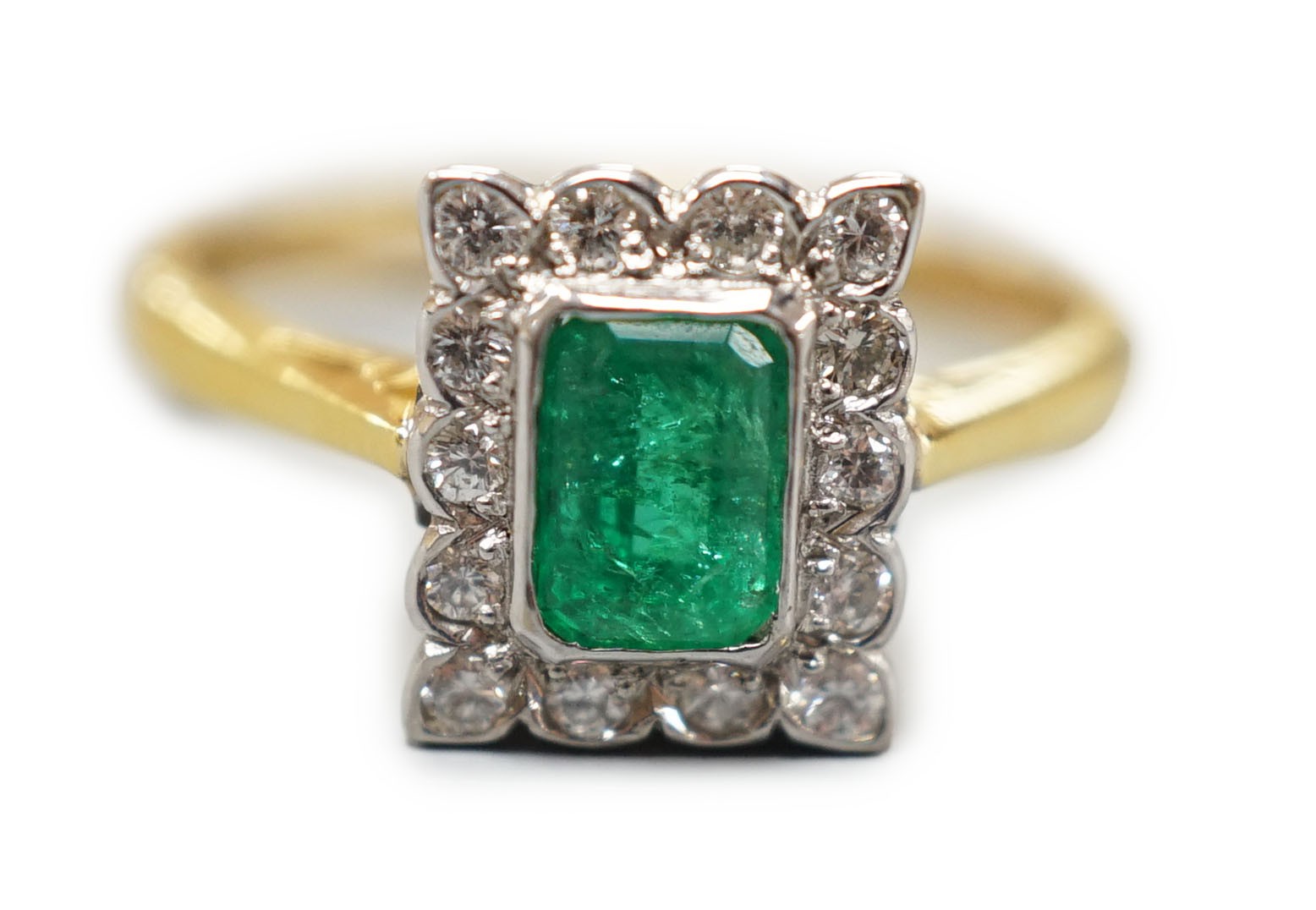 A modern 18ct gold, emerald and diamond set rectangular cluster ring, size N, gross weight 3.4 grams